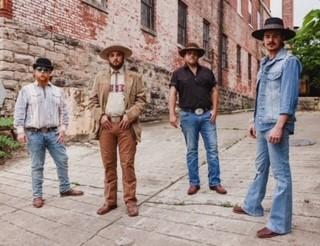 A group of men standing on the side walk