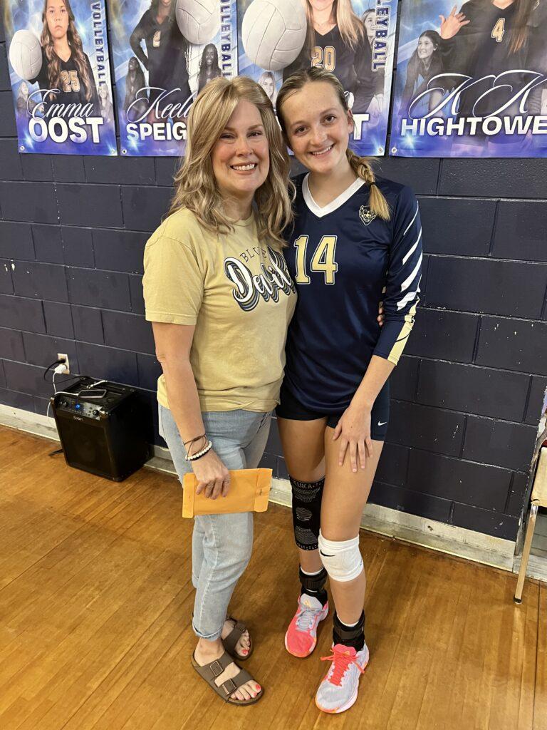 A woman and her daughter posing for a picture.