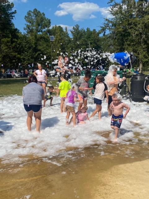 A group of people in the water at a beach.