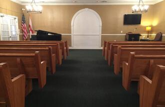 A church with pews and a piano in the middle of it