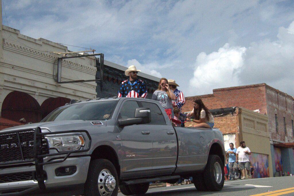 A truck with people in the back of it.