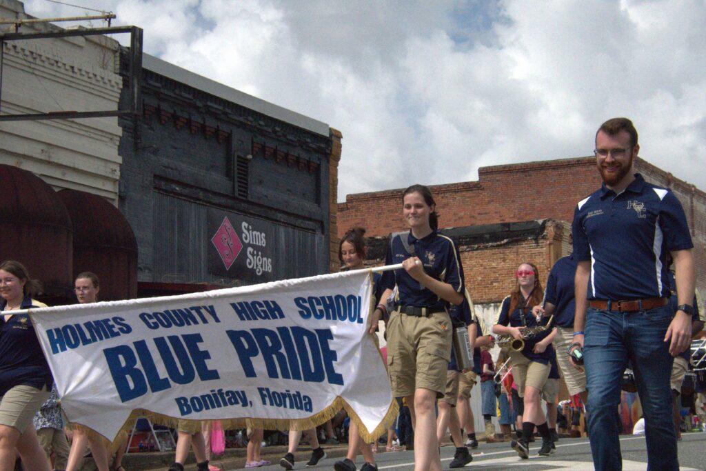 A group of people marching down the street.