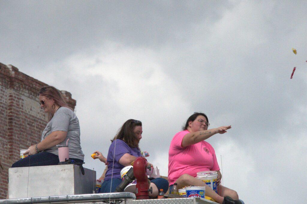 A group of people sitting on top of a platform.