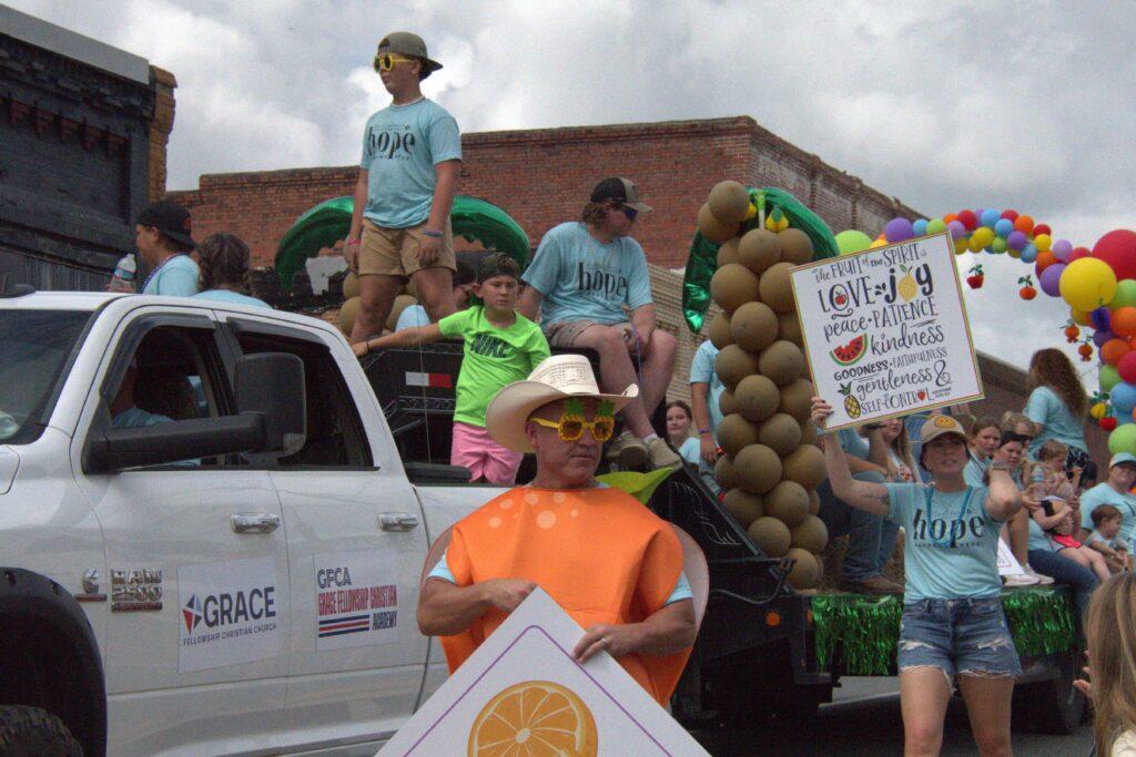 A group of people in costumes on the side of a road.