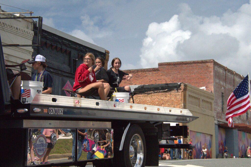 A truck with people sitting on it's back