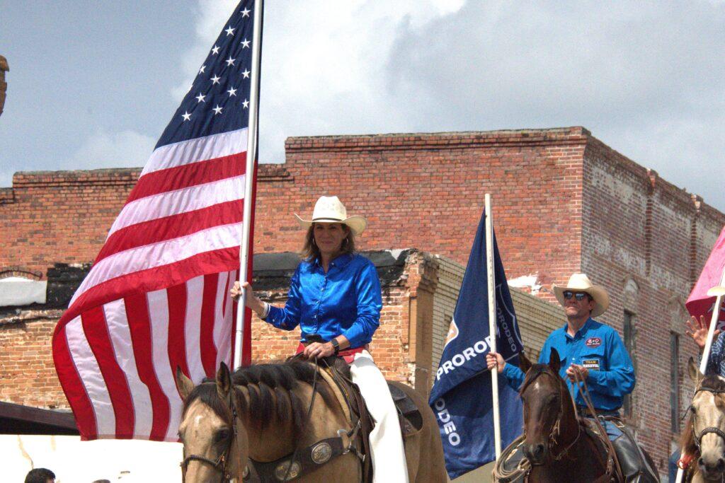 A woman riding on the back of a horse.