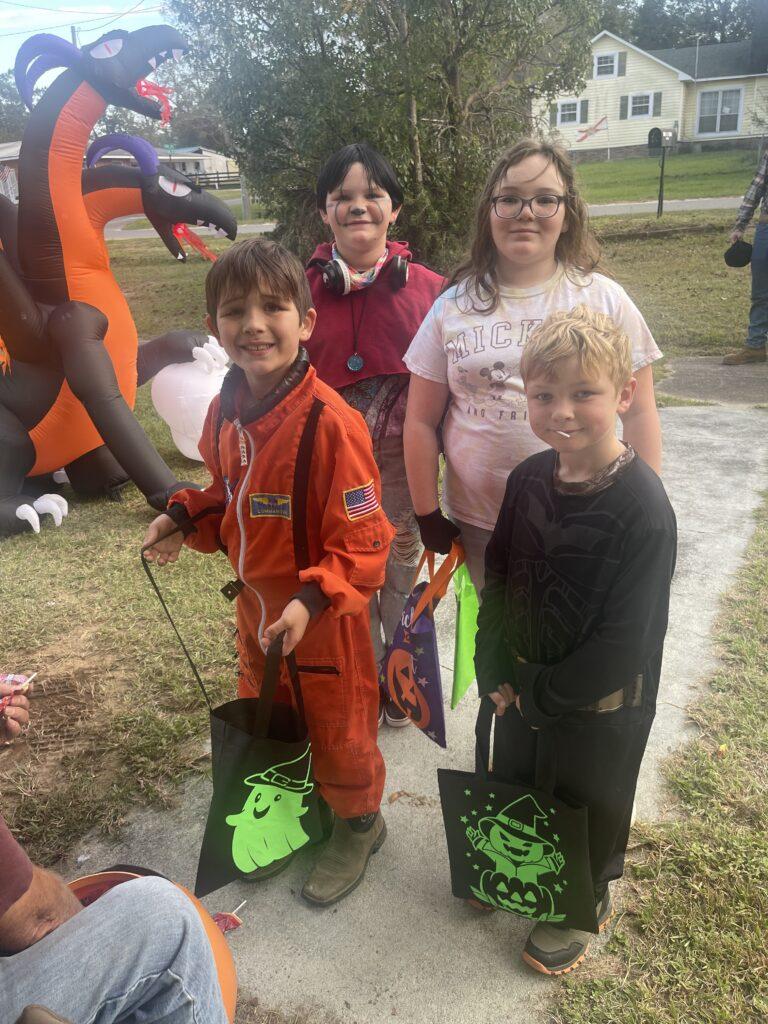 A group of kids in costumes at an event.