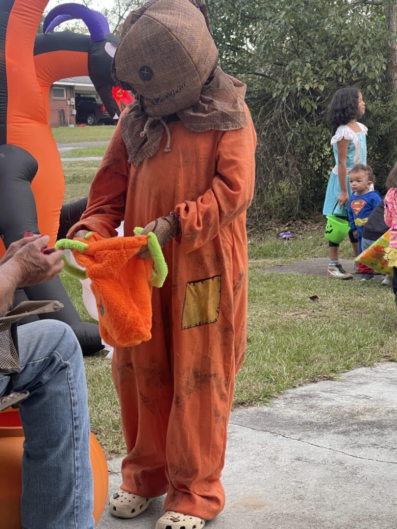 A person in an orange costume holding something