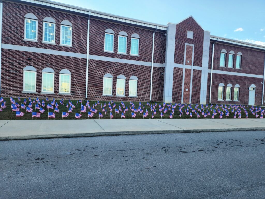 A building with many flags on the side of it.