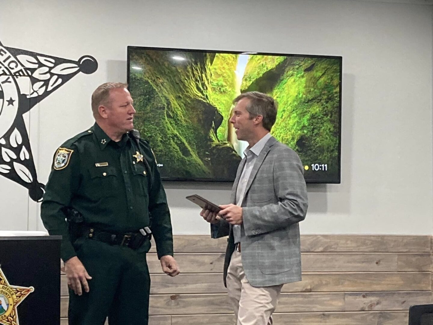 Sheriff speaking with suited man in meeting room Sheriff speaking with suited man in meeting room