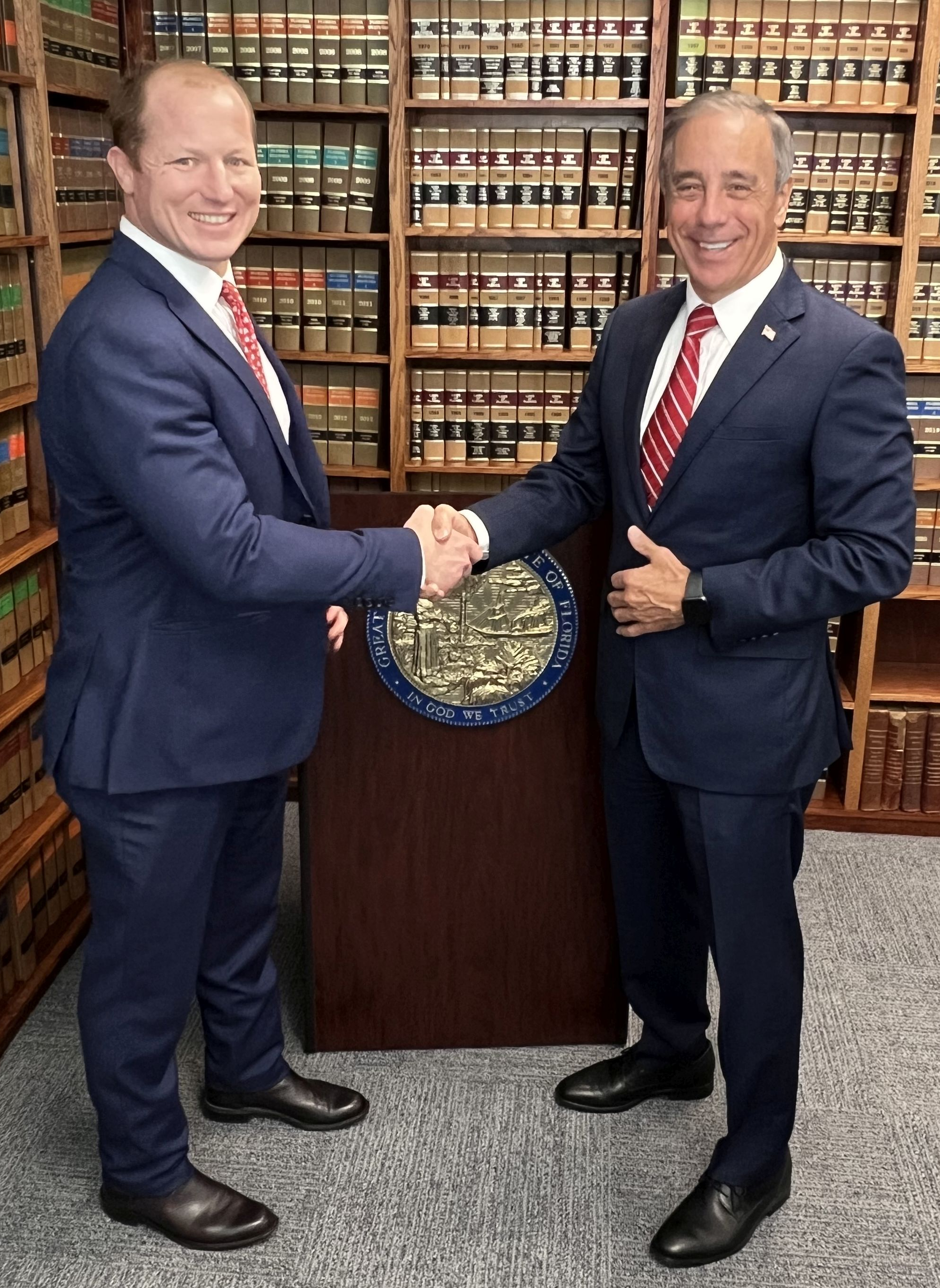 Two men in suits shaking hands