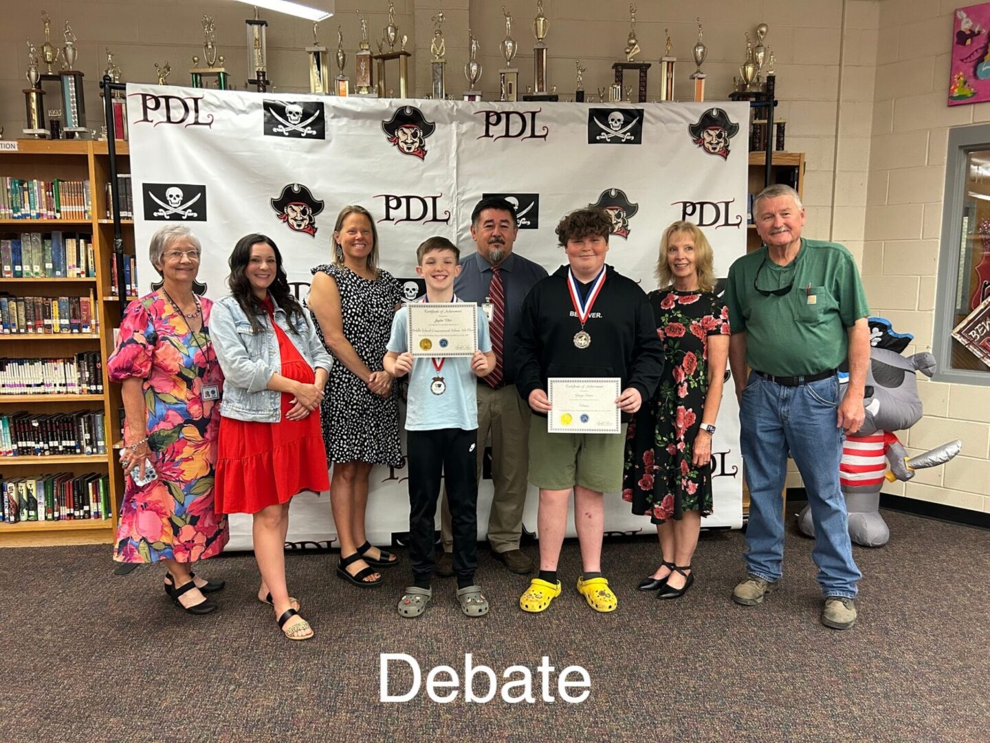 Debate winners with certificates and medals Debate winners with certificates and medals