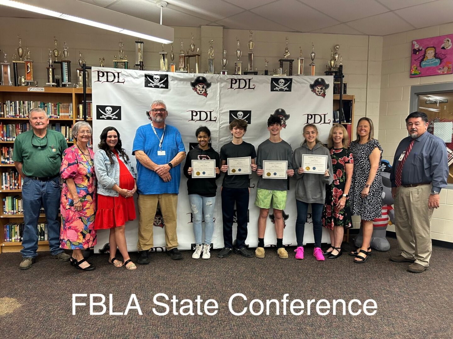 FBLA students and advisors posing with certificates