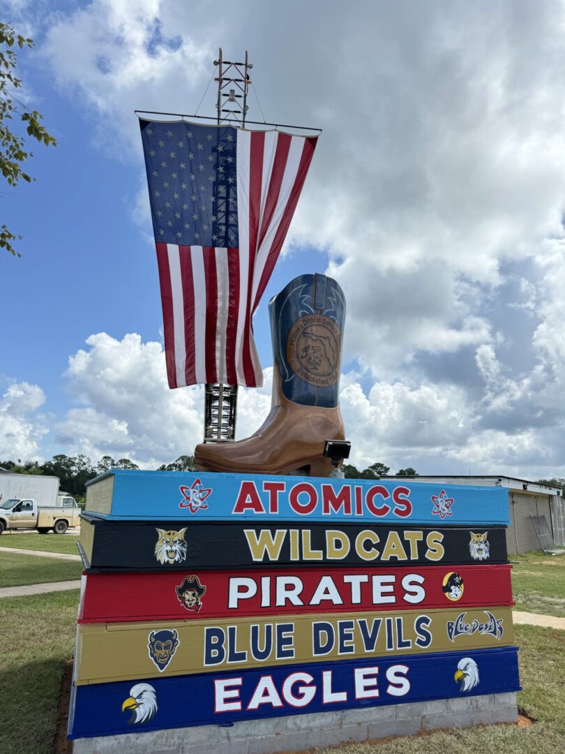 Giant cowboy boot, American flag, stacked team signs