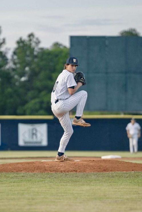 Baseball pitcher winding up on pitcher's mound