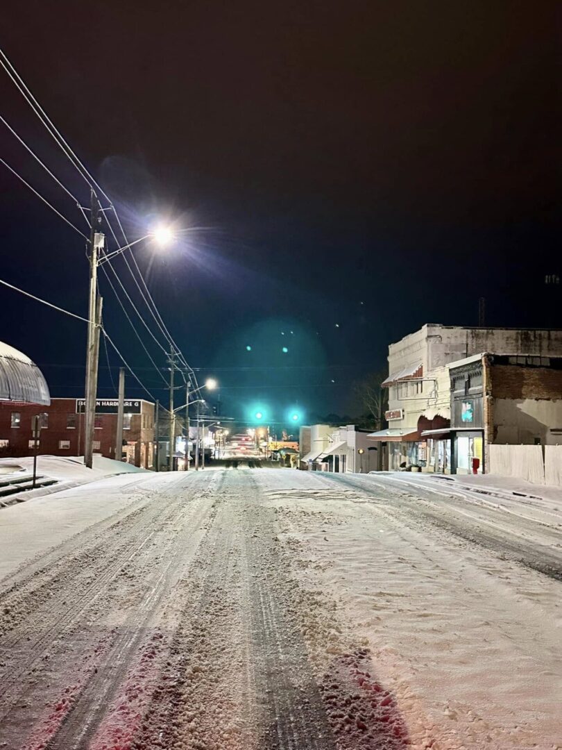 Snow-covered small-town street at night