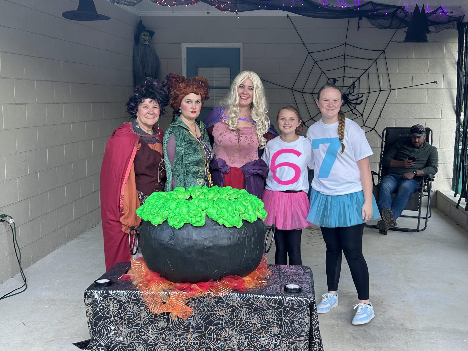 Group in Halloween costumes around bubbling cauldron Group in Halloween costumes around bubbling cauldron
