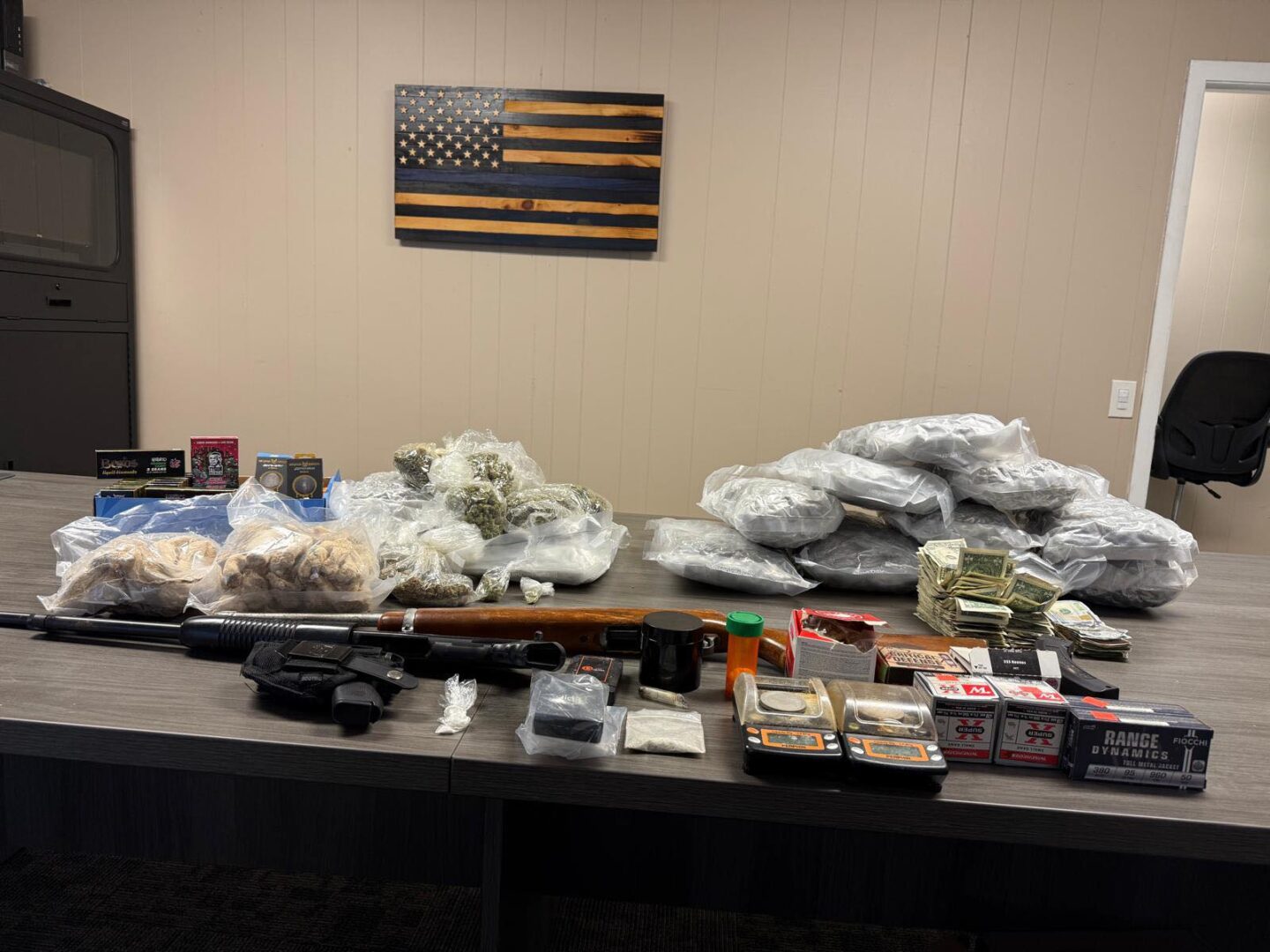 Table with guns, drugs, cash, ammunition