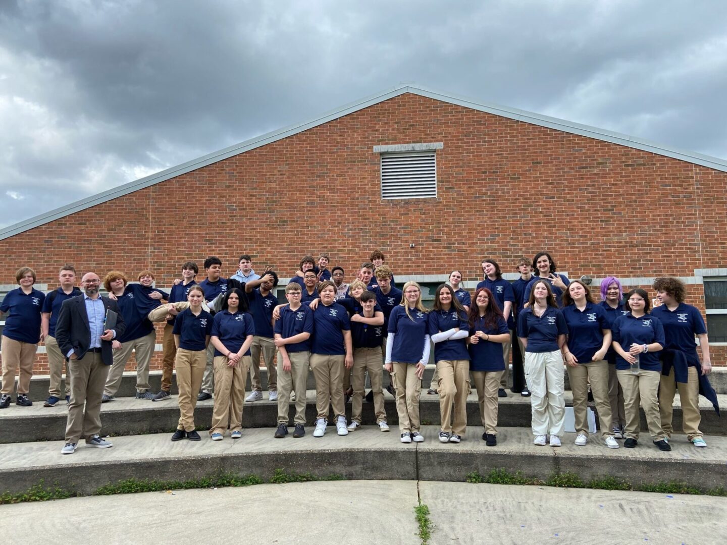 group of students in navy shirts outdoors